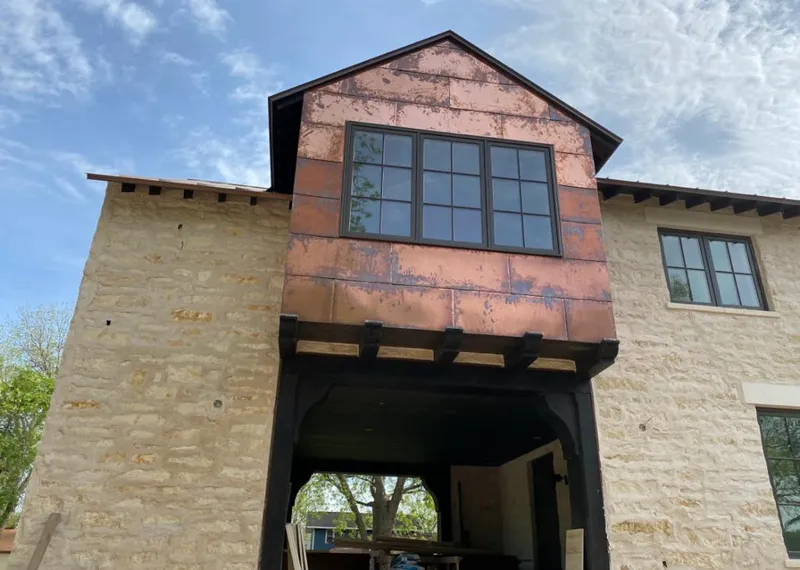 Copper metal panel facade on a stone building for Metal Roof Coating in Forest Lake