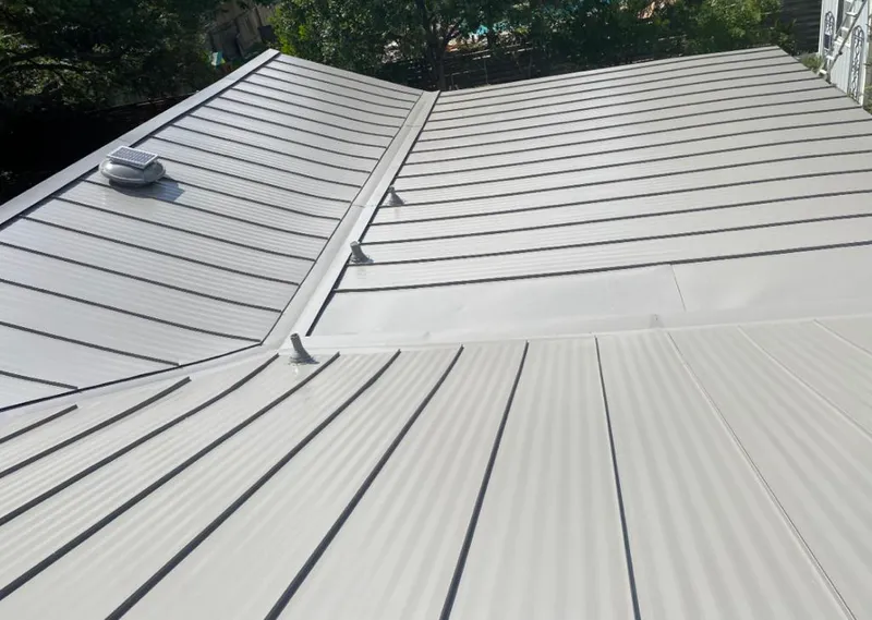 Solar attic fan installed on a metal roof for Roof Ventilation in Forest Lake